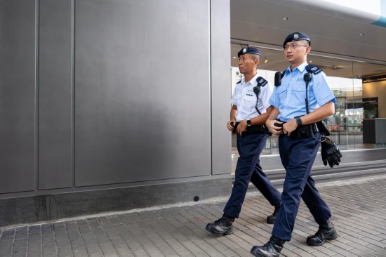 9月12日，配備國產(chǎn)新槍的警員在香港街頭巡邏。新華社記者 朱煒 攝